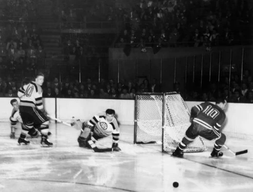 Edgar Laprade skates by the Boston Bruins net